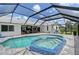 Screened-in pool with a jacuzzi, an outdoor seating area, and an updated patio at 3634 Torrey Pines Way Way, Sarasota, FL 34238
