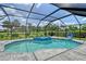 Beautiful screened-in pool with an attached jacuzzi, landscaped surroundings and blue finish at 3634 Torrey Pines Way Way, Sarasota, FL 34238