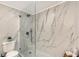 Elegant marble tiled shower with glass enclosure and contemporary fixtures at 3634 Torrey Pines Way Way, Sarasota, FL 34238
