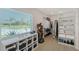 Spacious walk-in closet with window, custom shelves and laminate floors at 3634 Torrey Pines Way Way, Sarasota, FL 34238