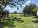 Large, grassy backyard with a shed and a patio set, enclosed by a chain-link fence at 4149 Prudence Dr, Sarasota, FL 34235