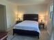 Cozy bedroom with a queen bed, bedside tables, lamps, and neutral walls with luxury vinyl flooring at 4149 Prudence Dr, Sarasota, FL 34235