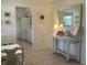 Bright entryway featuring neutral colors, a decorative table, and access to the kitchen and dining area at 4149 Prudence Dr, Sarasota, FL 34235