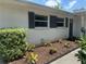 Exterior view of home with well-maintained landscaping and decorative shutters, creating a welcoming entrance at 4149 Prudence Dr, Sarasota, FL 34235