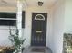 Close up of the front door with decorative window and ornate trim at 4149 Prudence Dr, Sarasota, FL 34235
