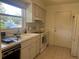 Functional kitchen featuring white appliances, ample counter space, and a window view at 4149 Prudence Dr, Sarasota, FL 34235