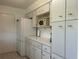 Spacious kitchen with bright white cabinetry, and modern appliances perfect for everyday living and entertaining at 4149 Prudence Dr, Sarasota, FL 34235