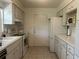 Well-maintained kitchen with ample storage, classic white appliances, and tile flooring for easy maintenance at 4149 Prudence Dr, Sarasota, FL 34235