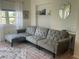 Comfortable living room with stylish sectional sofa, modern decor, and a plush area rug at 4149 Prudence Dr, Sarasota, FL 34235