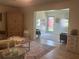 Cozy living room featuring neutral tones, wood floors, and an open doorway to an additional living space at 4149 Prudence Dr, Sarasota, FL 34235