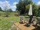 Outdoor patio featuring a dining table with umbrella and chairs, set on a pebble ground cover at 4149 Prudence Dr, Sarasota, FL 34235