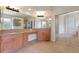 Primary bathroom features dual sinks, granite counters, and a large mirror at 4307 70Th E Ave, Ellenton, FL 34222