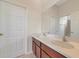 Bathroom with double sinks, wood cabinetry and framed mirror with entry to separate toilet at 4307 70Th E Ave, Ellenton, FL 34222