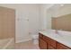 Bright bathroom featuring a ceramic tile floor, vanity with cherry colored cabinets, and cream colored walls at 4307 70Th E Ave, Ellenton, FL 34222
