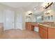 Spacious bathroom featuring double vanities, framed mirrors, and neutral tile flooring at 4307 70Th E Ave, Ellenton, FL 34222