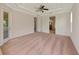 Large carpeted primary bedroom featuring ceiling fan, and dual door entrances at 4307 70Th E Ave, Ellenton, FL 34222