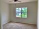 Bedroom with a window offering a view of the outdoors and a neighboring house, enhancing the living space at 4307 70Th E Ave, Ellenton, FL 34222