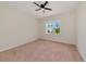 Spacious carpeted bedroom with ceiling fan, and view to back yard at 4307 70Th E Ave, Ellenton, FL 34222