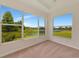 Bedroom featuring carpeted floors, a scenic lake view, and ample natural lighting at 4307 70Th E Ave, Ellenton, FL 34222