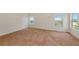 Large bright carpeted bedroom with large windows offering a picturesque view of the outdoors at 4307 70Th E Ave, Ellenton, FL 34222