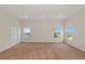 Large carpeted bedroom with bright walls, recessed lighting, and multiple windows offering a peaceful view at 4307 70Th E Ave, Ellenton, FL 34222