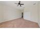 Spacious carpeted bedroom with ceiling fan, closet and entry to hallway at 4307 70Th E Ave, Ellenton, FL 34222