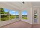 Bedroom with carpet, tray ceiling, and scenic views from multiple windows overlooking the backyard at 4307 70Th E Ave, Ellenton, FL 34222