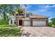 Stunning two-story home with stone accents, a three-car garage, and a beautiful brick driveway at 4307 70Th E Ave, Ellenton, FL 34222