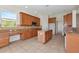 Well-lit kitchen with a center island, granite countertops, and wooden cabinetry at 4307 70Th E Ave, Ellenton, FL 34222