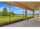 Relaxing screened-in lanai with a picturesque view of the lake and lush greenery at 4307 70Th E Ave, Ellenton, FL 34222