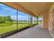 Relaxing screened-in lanai with a picturesque view of the lake and lush greenery at 4307 70Th E Ave, Ellenton, FL 34222