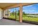 Relaxing screened-in lanai with a picturesque view of the lake and lush greenery at 4307 70Th E Ave, Ellenton, FL 34222
