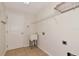 Functional laundry room featuring a utility sink, tile flooring, and white walls at 4307 70Th E Ave, Ellenton, FL 34222