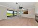 Spacious living room with sliding glass doors offering water views, a fireplace, and an adjacent kitchen at 4307 70Th E Ave, Ellenton, FL 34222