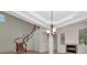 Living room showcasing winding staircase, a fireplace, and a chandelier, with views into other rooms at 4307 70Th E Ave, Ellenton, FL 34222