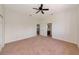 Spacious carpeted bedroom with view to ensuite bathroom, and large closet at 4307 70Th E Ave, Ellenton, FL 34222