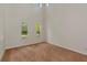 Bright, carpeted room with large windows letting in ample natural light, showcasing the tall ceilings at 4307 70Th E Ave, Ellenton, FL 34222