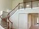Elegant curved staircase with wood railing and white spindles in a home with high ceilings at 4307 70Th E Ave, Ellenton, FL 34222