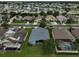 A beautiful aerial view of a neighborhood featuring well-maintained lawns and a community pond at 4360 85Th Avenue E Cir, Parrish, FL 34219