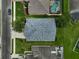 Aerial view showcases the home's roof, neighboring pool, and proximity to the road at 4360 85Th Avenue E Cir, Parrish, FL 34219