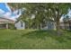 The lush backyard features a mature tree providing ample shade at 4360 85Th Avenue E Cir, Parrish, FL 34219