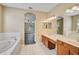 Bright bathroom with double sink vanity, soaking tub and tile floors throughout at 4360 85Th Avenue E Cir, Parrish, FL 34219