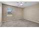 Cozy bedroom with plush carpet, a ceiling fan, and a window with backyard views at 4360 85Th Avenue E Cir, Parrish, FL 34219