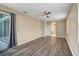 Spacious primary bedroom with luxury vinyl floors, ceiling fan, and outdoor access at 4360 85Th Avenue E Cir, Parrish, FL 34219