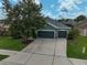 The home's exterior boasts a three-car garage, well-kept landscaping and modern roof at 4360 85Th Avenue E Cir, Parrish, FL 34219