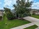 Well-manicured front lawn and a mature tree enhance the curb appeal of this home at 4360 85Th Avenue E Cir, Parrish, FL 34219