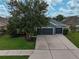 The home's exterior features a three-car garage and a well-maintained lawn at 4360 85Th Avenue E Cir, Parrish, FL 34219