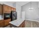 Well-equipped kitchen featuring an island, stainless appliances, and wood cabinets at 4360 85Th Avenue E Cir, Parrish, FL 34219
