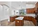 Well-lit kitchen featuring an island, breakfast bar, wood cabinets and granite countertops at 4360 85Th Avenue E Cir, Parrish, FL 34219