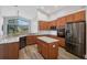Spacious kitchen featuring granite countertops, stainless appliances, and wood cabinets at 4360 85Th Avenue E Cir, Parrish, FL 34219
